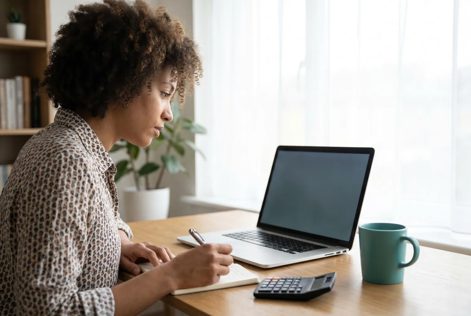 An adult at a home desk reviewing the cost of online psychiatry on a laptop An adult at a home desk reviewing the cost of online psychiatry on a laptop