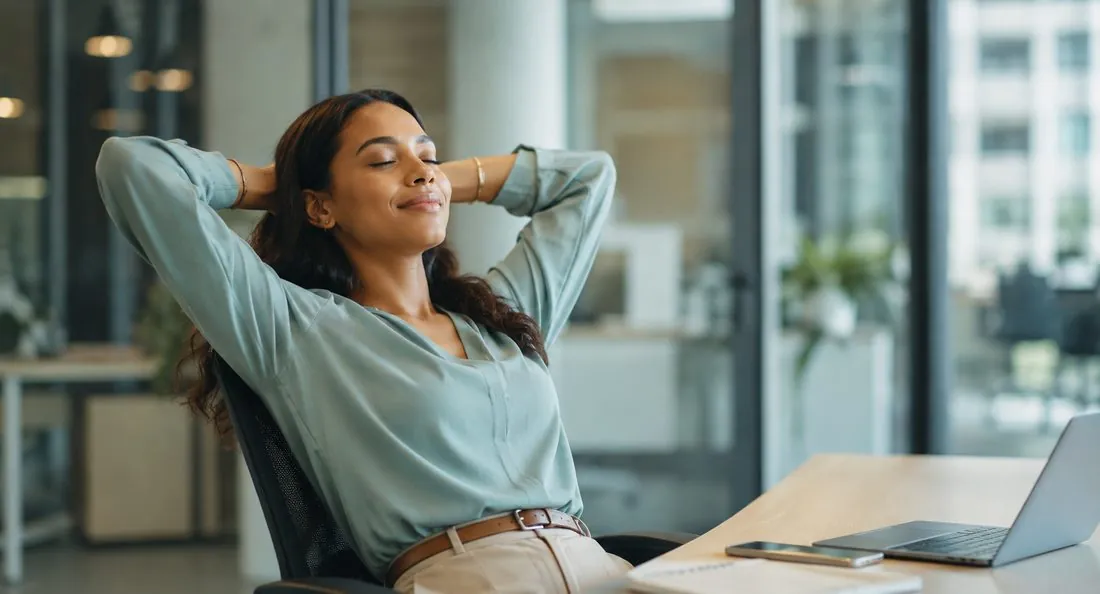 A relieved adult relaxing at her office desk after starting GAD care A relieved adult relaxing at her office desk after starting GAD care