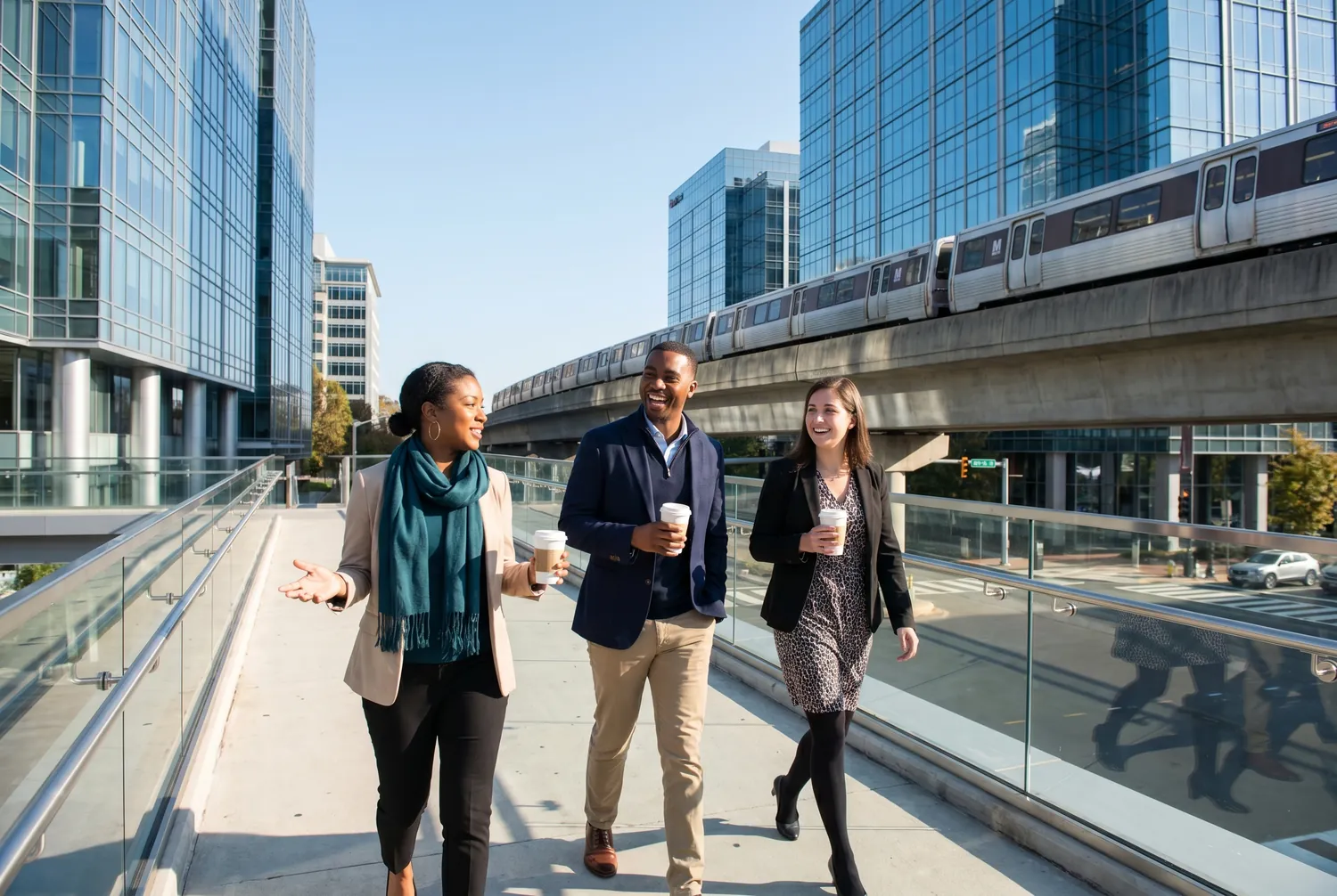 Colleagues walking a modern plaza beneath Tysons office towers Colleagues walking a modern plaza beneath Tysons office towers
