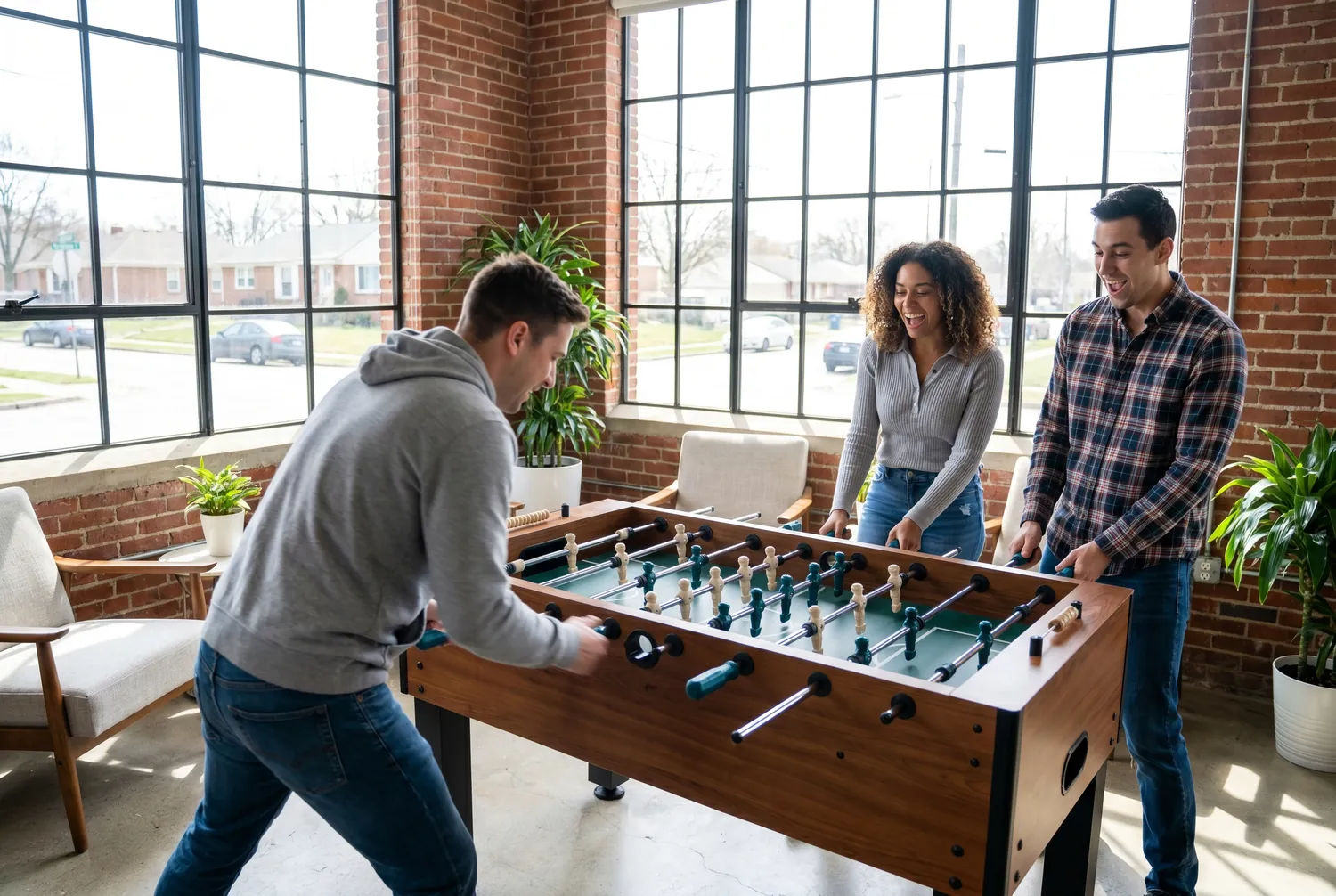 Foosball match in a modern Fishers office lounge
