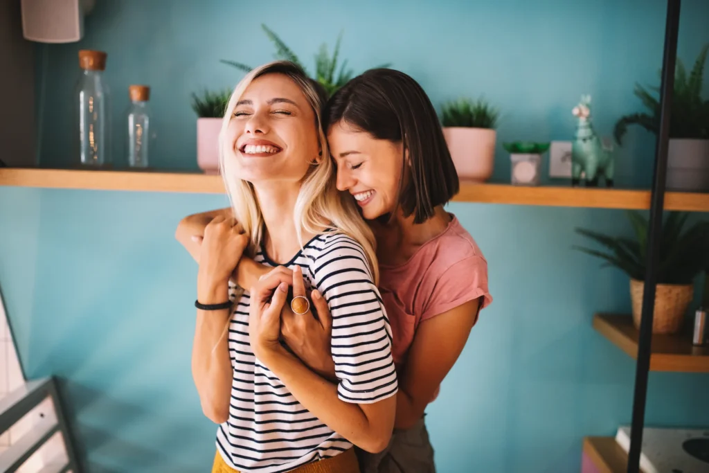 two young girls hugging and smiling