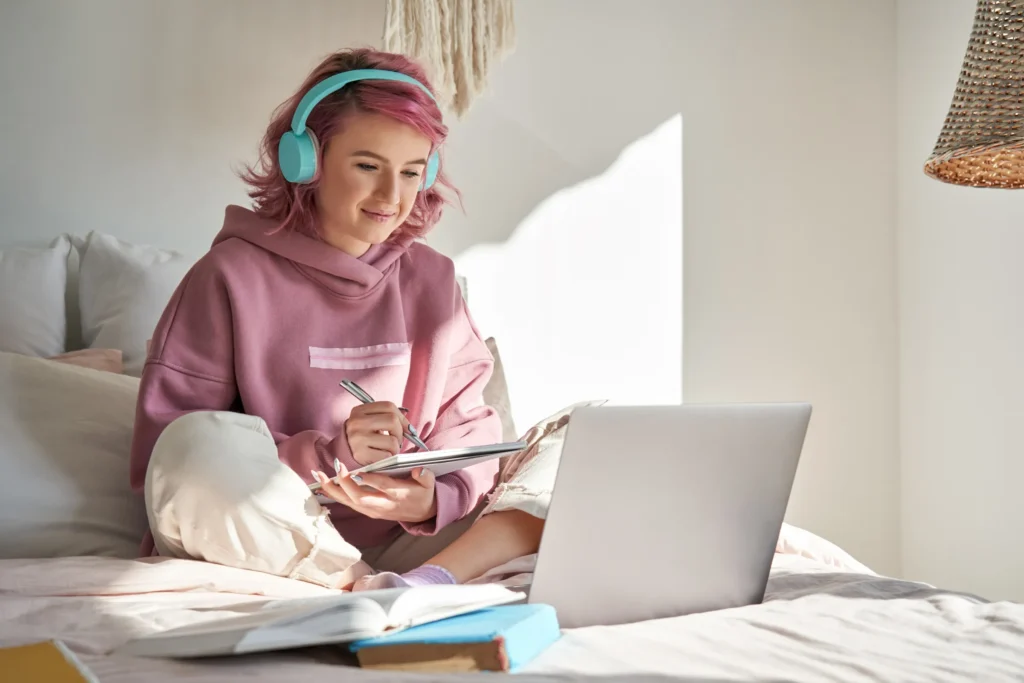 woman looking at laptop with headphones in