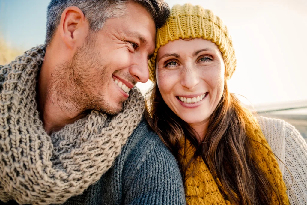 happy couple taking a selfie, they are dressed for cold weather