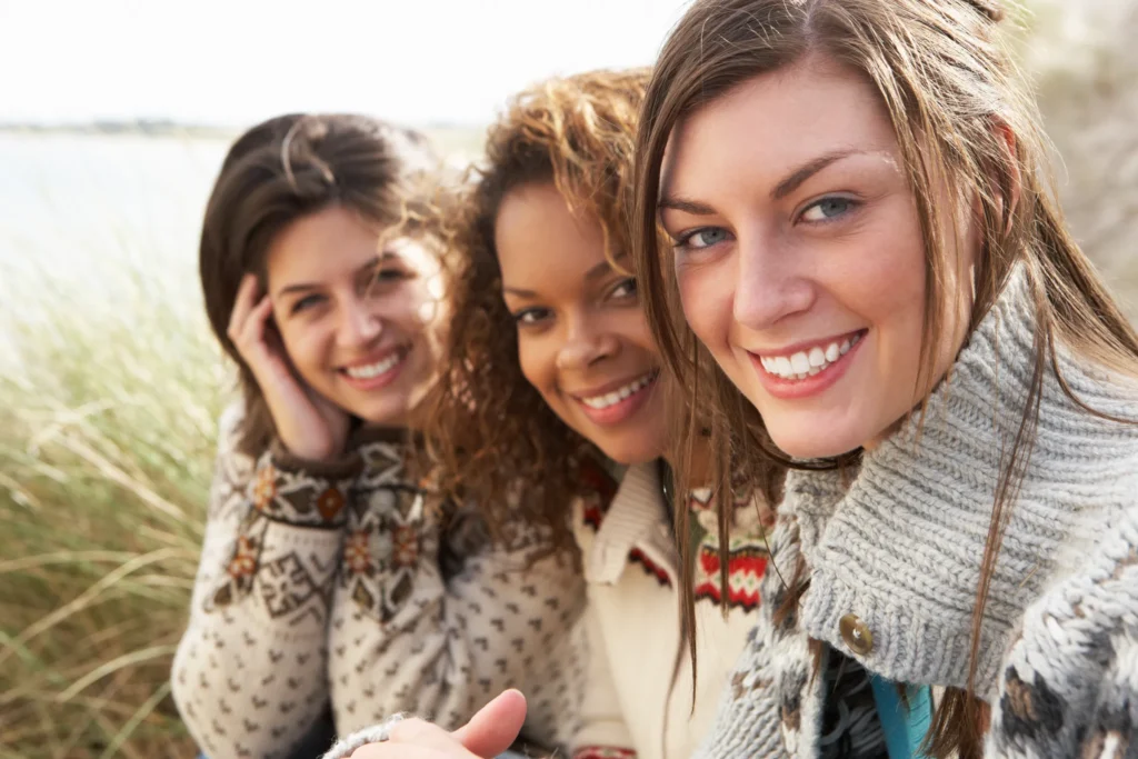 three woman smiling for selfie