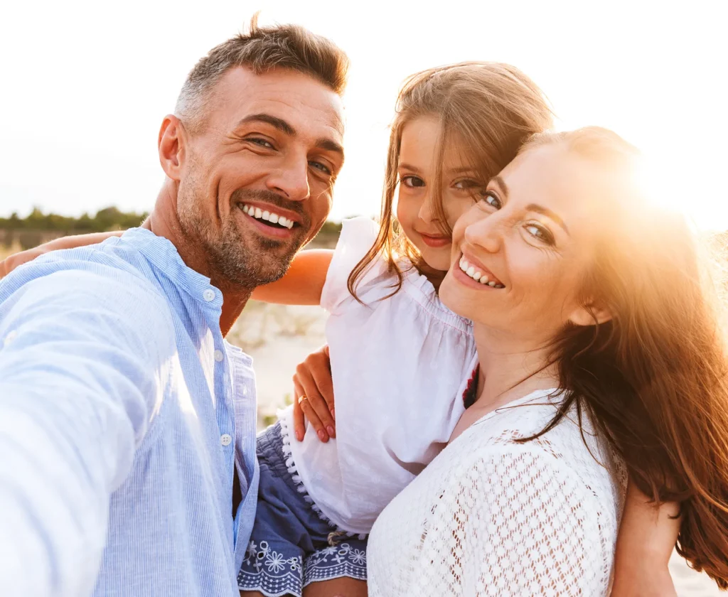 selfie of couple and daughter smiling