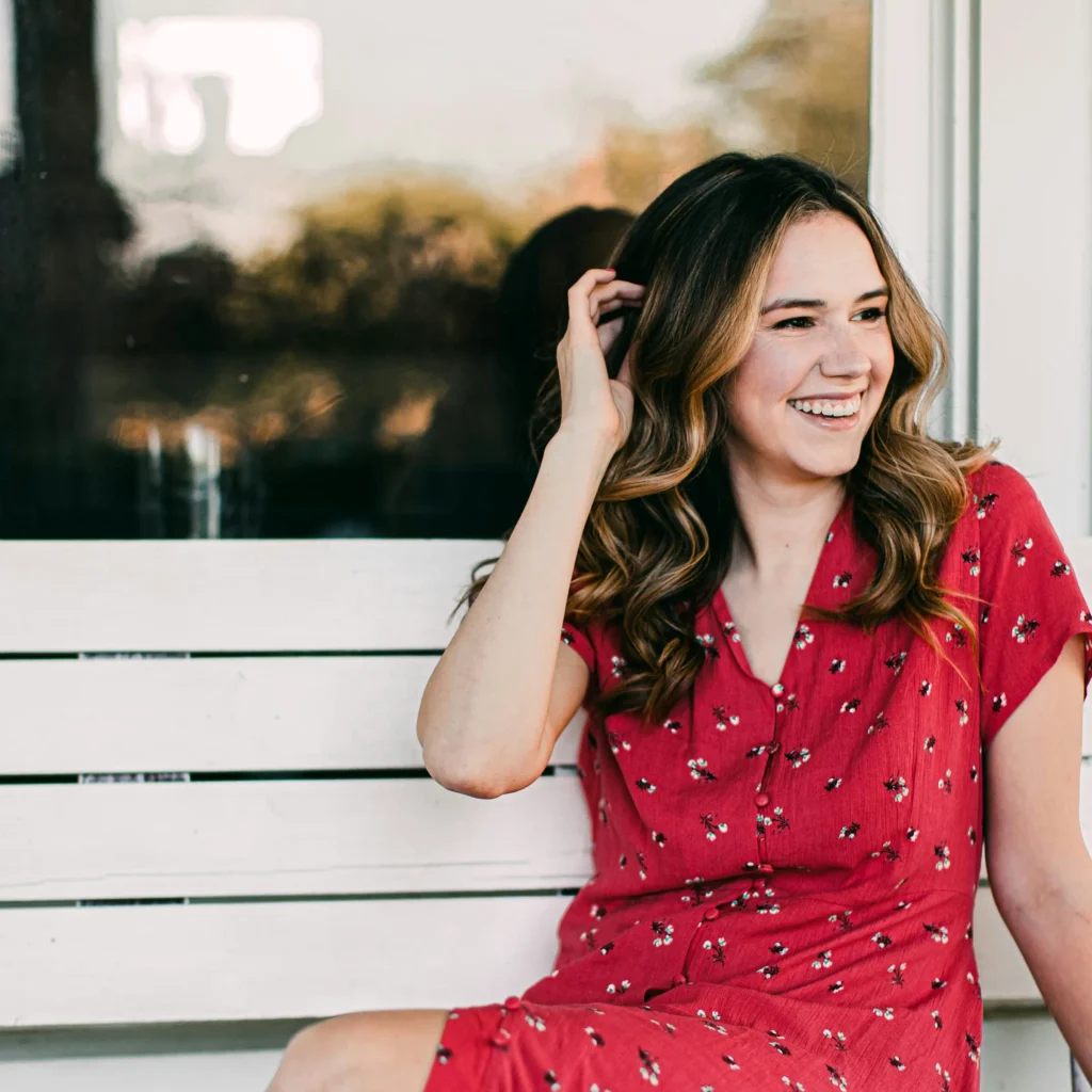 Woman sitting on bench looking off camera