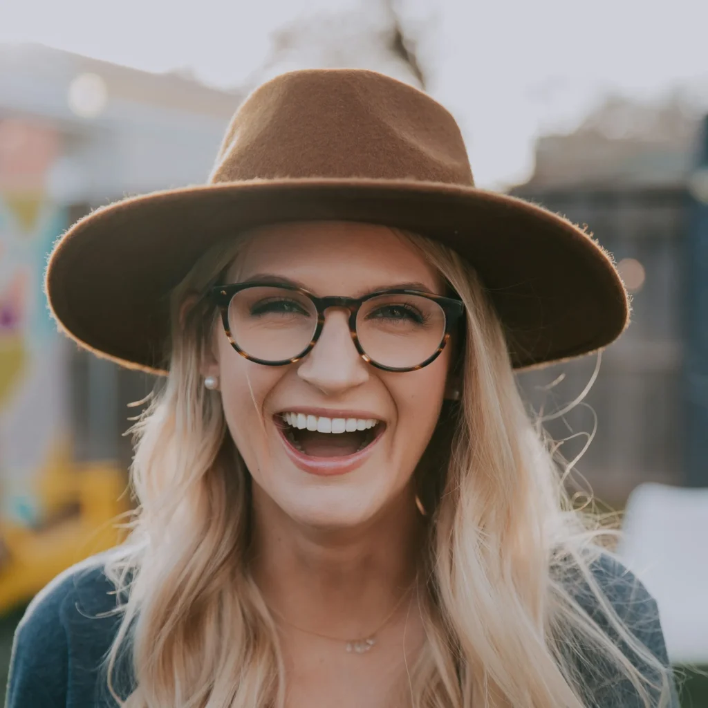 woman wearing cowboy hat smiling