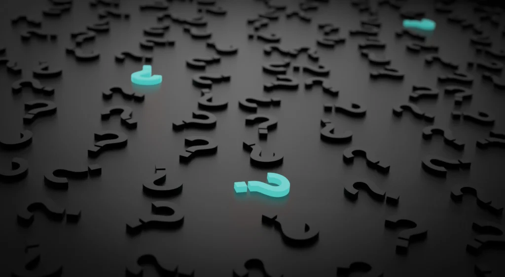 Glowing question marks representing common questions about whether to see a psychiatrist or a psychologist for mental health care.